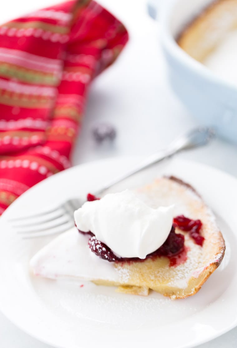 This eggnog dutch baby is a great holiday brunch pancake with perfectly spiced pancake batter and cranberry compote topping.