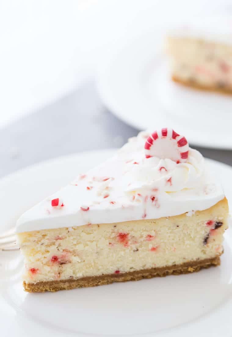 This peppermint white chocolate cheesecake recipe is creamy with white chocolate filling, crunchy peppermint chocolate bark and topped with whipped cream. 