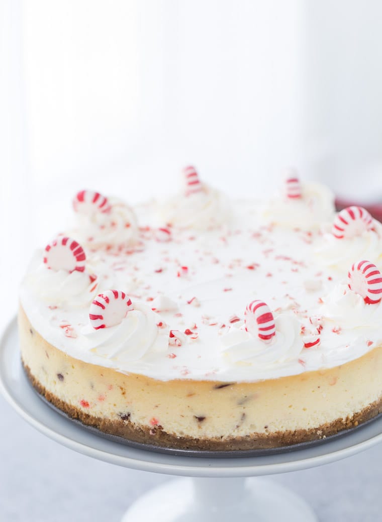 This peppermint white chocolate cheesecake recipe is creamy with white chocolate filling, crunchy peppermint chocolate bark and topped with whipped cream. 