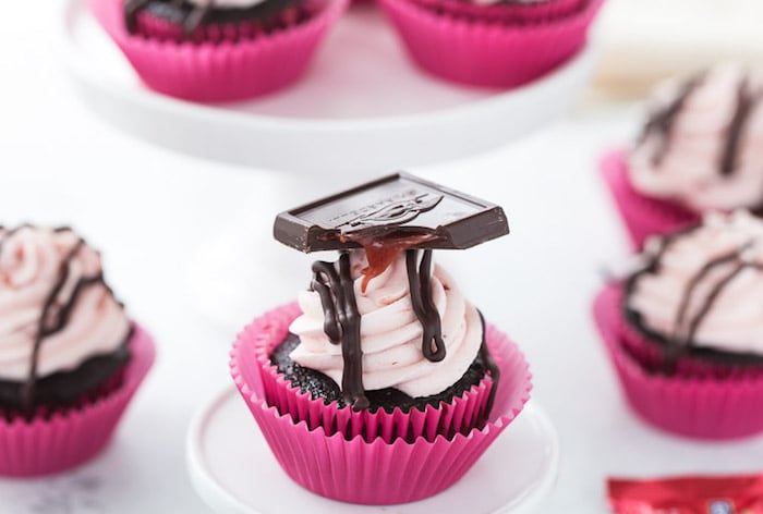 These chocolate strawberry cupcakes are perfect for your Valentine! Decadent dark chocolate cupcakes topped with a whipped fresh strawberry frosting. 