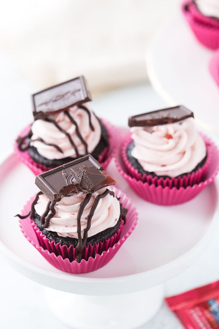 These chocolate strawberry cupcakes are perfect for your Valentine! Decadent dark chocolate cupcakes topped with a whipped fresh strawberry frosting. 