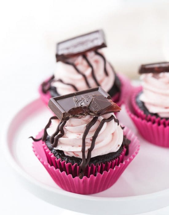 These chocolate strawberry cupcakes are perfect for your Valentine! Decadent dark chocolate cupcakes topped with a whipped fresh strawberry frosting.