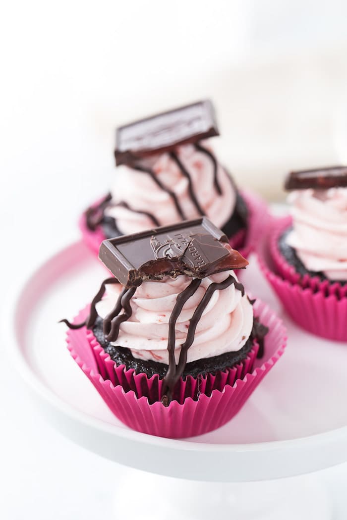 These chocolate strawberry cupcakes are perfect for your Valentine! Decadent dark chocolate cupcakes topped with a whipped fresh strawberry frosting. 