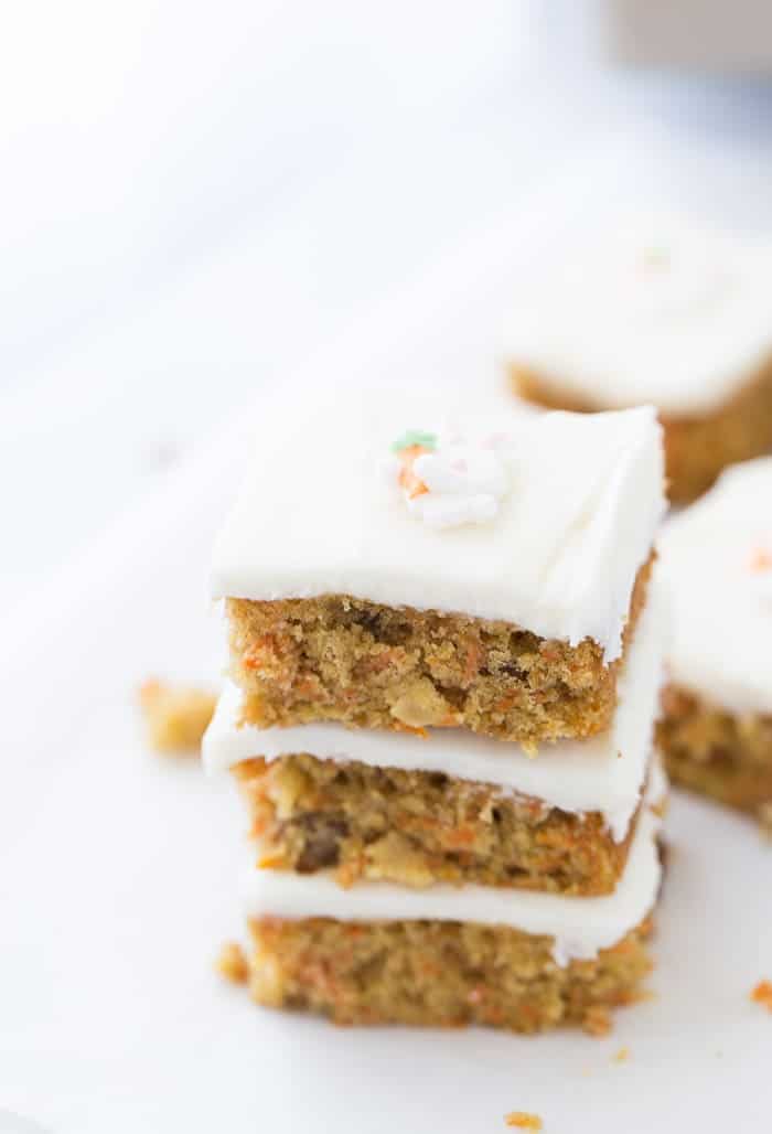 These carrot cake bars are your favorite Easter recipe with perfectly spiced carrot cake and a sweet orange cream cheese frosting.