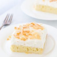 This Coconut Tres Leches Cake is your classic tres leche cake oozing with sweet coconut milk, dark rum and a fresh whipped coconut cream.