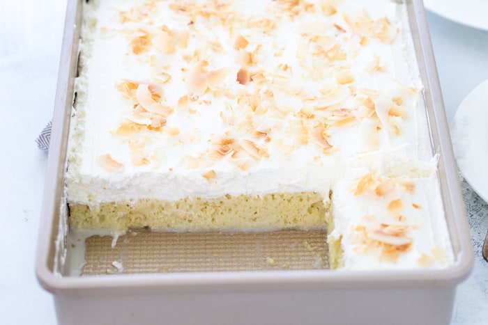 This Coconut Tres Leches Cake is your classic tres leche cake oozing with sweet coconut milk, dark rum and a fresh whipped coconut cream. 