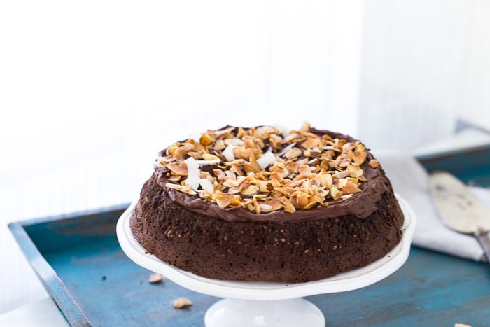 This flourless chocolate coconut cake has a decadent chocolate cake topped with whipped chocolate ganache and a crunchy coconut almond topping.