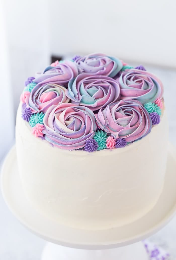 This white chocolate rose cake is an incredibly moist vanilla bean cake with hints of floral rose water and whipped white chocolate frosting. 
