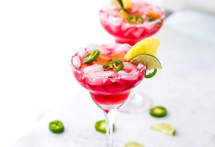 An easy and refreshing Hibiscus Margaritas with sweet pineapple infused syrup and hint of spicy with jalepenos. The perfect mix of sweet and spicy.