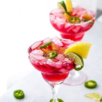 An easy and refreshing Hibiscus Margaritas with sweet pineapple infused syrup and hint of spicy with jalepenos. The perfect mix of sweet and spicy.