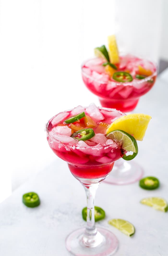 An easy and refreshing Hibiscus Margaritas with sweet pineapple infused syrup and hint of spicy with jalepenos. The perfect mix of sweet and spicy.