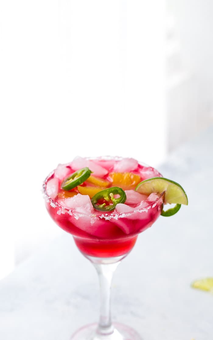 An easy and refreshing Hibiscus Margaritas with sweet pineapple infused syrup and hint of spicy with jalepenos. The perfect mix of sweet and spicy.