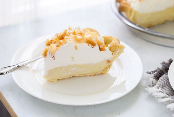 This is your classic coconut cream pie recipe with a sweet silky custard filling rich in coconut flavor. It's the perfect summer pie!