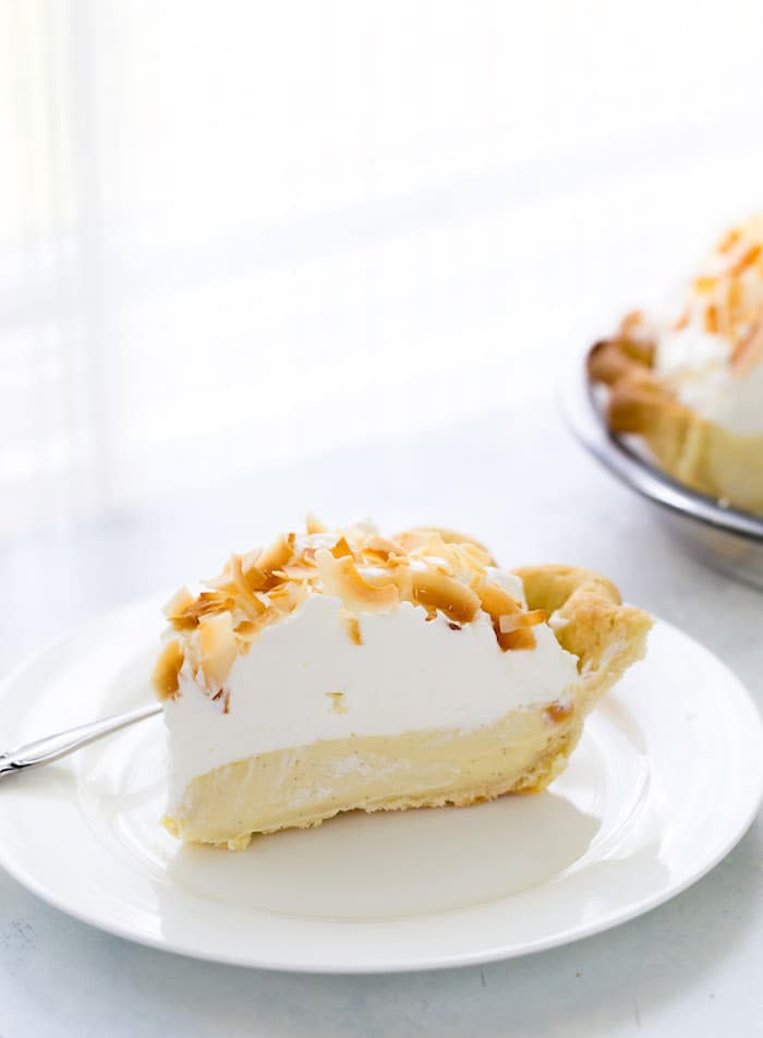 This is your classic coconut cream pie recipe with a sweet silky custard filling rich in coconut flavor. It's the perfect summer pie!