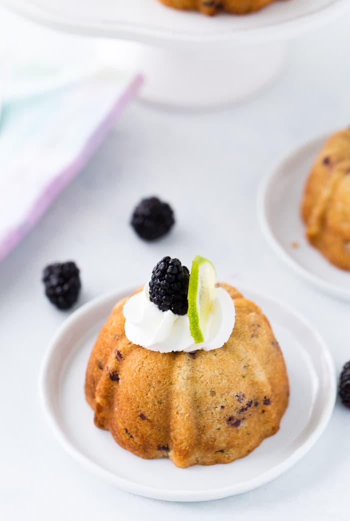 These blackberry lime mojito cakes are deliciously tender and filled with fresh blackberries and rum topped with fresh whipped cream.