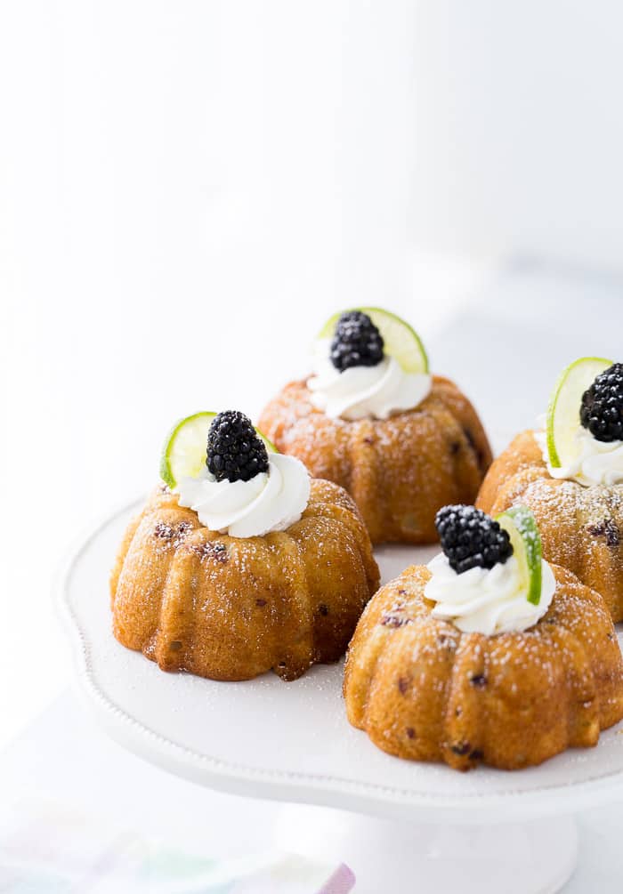 These blackberry lime mojito cakes are deliciously tender and filled with fresh blackberries and rum topped with fresh whipped cream.