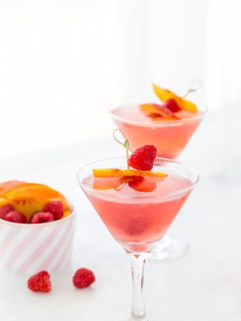 This summer peach raspberry martini recipe is filled with fresh raspberries and juicy peach flavors. A refreshing summer cocktail that's easy to whip up.