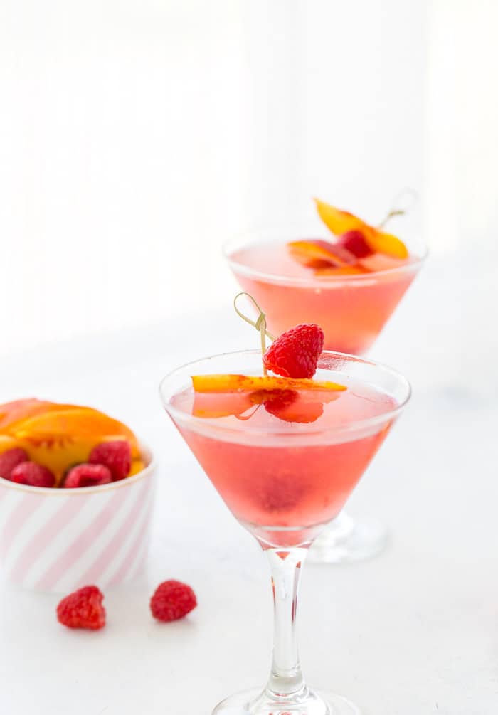 This summer peach raspberry martini recipe is filled with fresh raspberries and juicy peach flavors. A refreshing summer cocktail that's easy to whip up. 