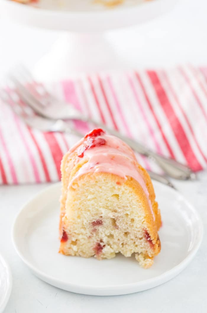 This strawberry lemonade pound cake starts with a luscious lemon pound cake mix infused with strawberries and topped with a fresh strawberry glaze. 
