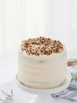 A classic hummingbird cake with a pineapple, banana and pecan spiced cake topped with cream cheese frosting. A moist spiced cake full of bold flavors.