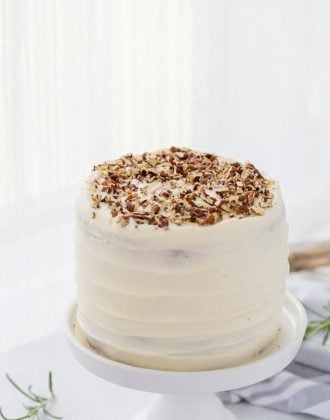 A classic hummingbird cake with a pineapple, banana and pecan spiced cake topped with cream cheese frosting. A moist spiced cake full of bold flavors.
