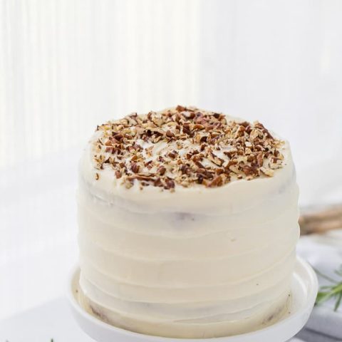 A classic hummingbird cake with a pineapple, banana and pecan spiced cake topped with cream cheese frosting. A moist spiced cake full of bold flavors.