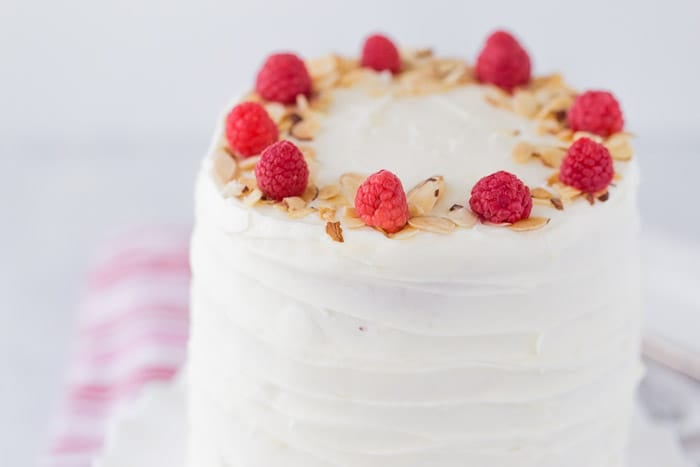 A luscious lemon raspberry cake recipe that is filled with a whipped honey mascarpone filling, raspberry compote and sweet cream cheese frosting. 