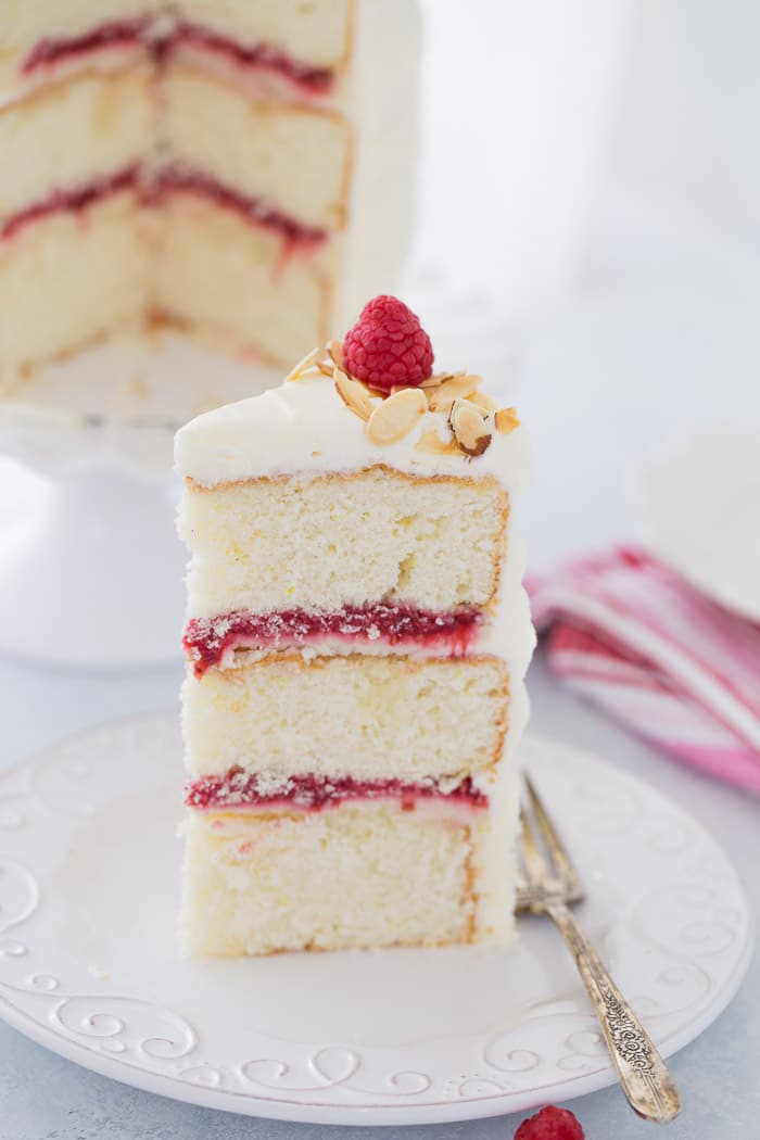 A luscious lemon raspberry cake recipe that is filled with a whipped honey mascarpone filling, raspberry compote and sweet cream cheese frosting. 