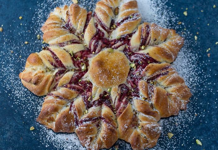 This Cranberry Cinnamon Star Bread is a holiday spectacular with a warm cranberry, brie and pistachio filling wrapped around a fluffy bread. 