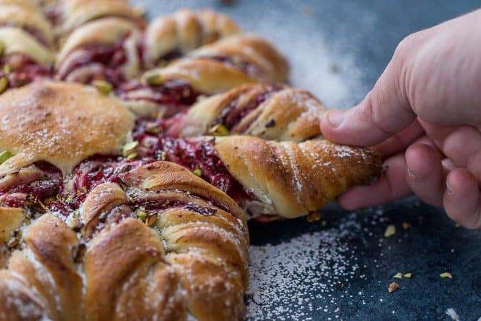 This Cranberry Cinnamon Star Bread is a holiday spectacular with a warm cranberry, brie and pistachio filling wrapped around a fluffy bread. 