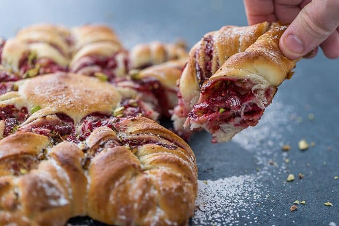 This Cranberry Cinnamon Star Bread is a holiday spectacular with a warm cranberry, brie and pistachio filling wrapped around a fluffy bread. 