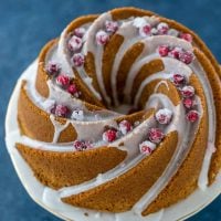 Moist eggnog bundt cake, lightly spiced with cinnamon and nutmeg and ribbon of cranberry sauce, topped with a rum glaze. A simple holiday cake recipe!