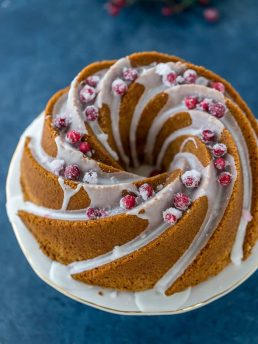 Moist eggnog bundt cake, lightly spiced with cinnamon and nutmeg and ribbon of cranberry sauce, topped with a rum glaze. A simple holiday cake recipe!