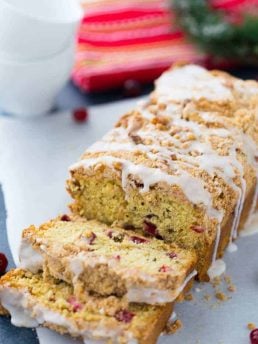 This Cranberry Orange Coffee Cake is a moist crumb cake that will brighten up any cold winter night! Get the quick and easy coffee cake recipe here!