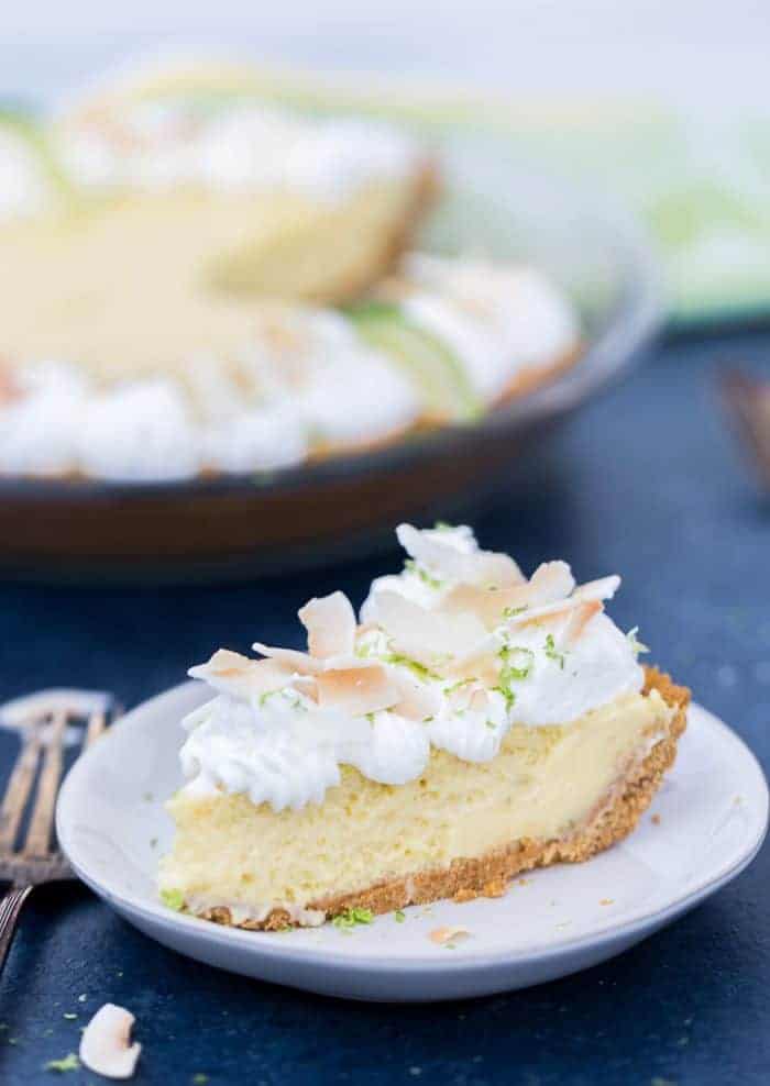 This coconut key lime pie brings sweet tropical flavors to your classic key lime pie recipe. With a chewy, crunchy coconut graham cracker crust, the filling is tart, creamy and delicious. Perfect for spring and summer.