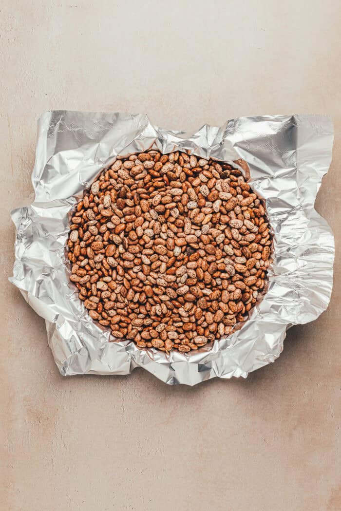 Weights added to an unbaked tart crust.