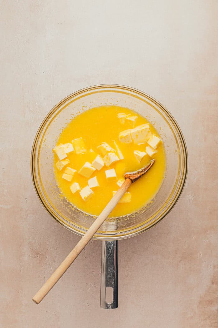 In a large bowl, a lemon custard filling is slowly being cooked.