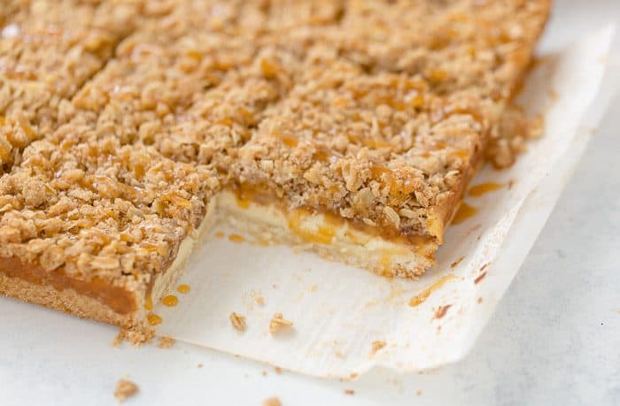 A triple layer of apples, cheesecake and crumb coat make these apple crumble cheesecake bars a different take on a classic fall dessert.