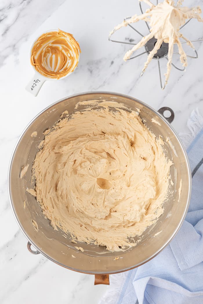 Peanut Butter Buttercream being mixed in a bowl.