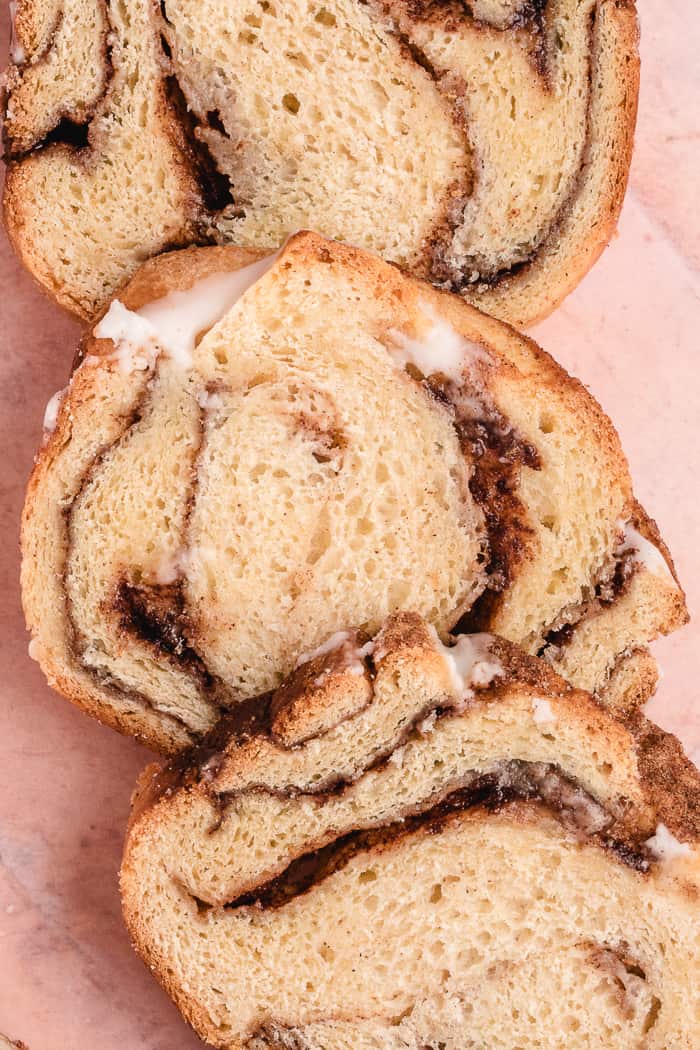 Cinnamon Swirl Bread sliced with icing drizzled on it. 