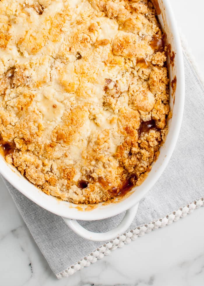 Easy Apple Cobbler showing the cobbler topping in a casserole dish. 