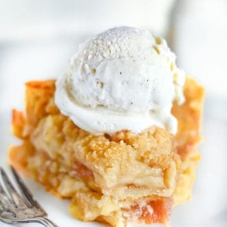 A slice of Dutch Apple Pie with ice cream on top