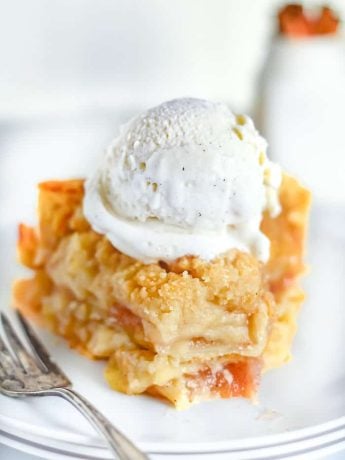 A slice of Dutch Apple Pie with ice cream on top
