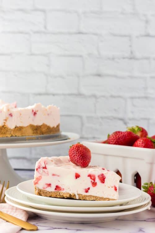 A slice of no bake strawberry cheesecake on a plate. 