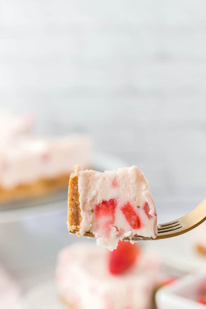A bite of no bake strawberry cheesecake. 