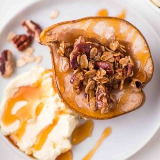 Baked pears on a plate with mascarpone and honey