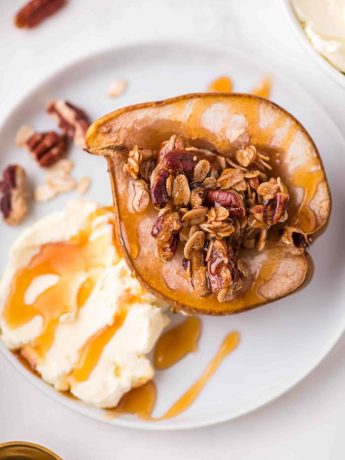 Baked pears on a plate with mascarpone and honey