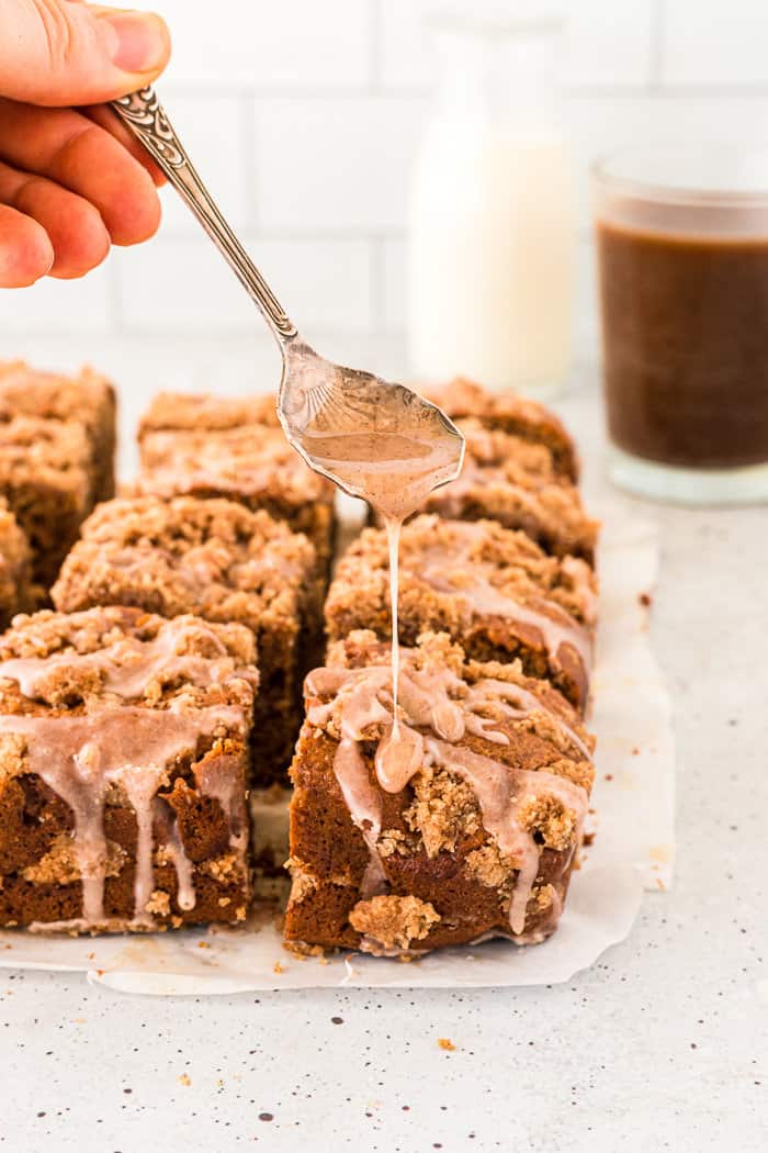 Chai coffee cake with a glaze drizzled all over it.