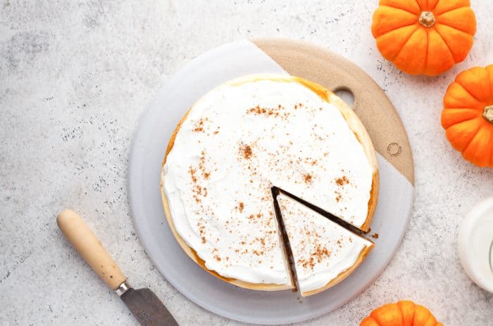 Instant pot pumpkin cheesecake with a slice cut into it.