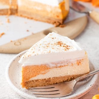 A slice of instant pot pumpkin cheesecake on a plate.